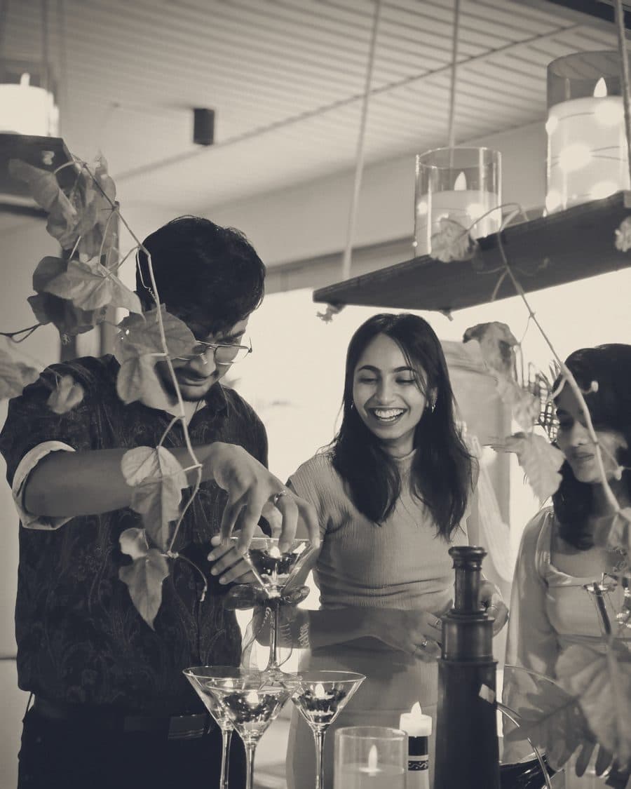 Guests laughing while a champagne tower is poured at the Cantine dinner