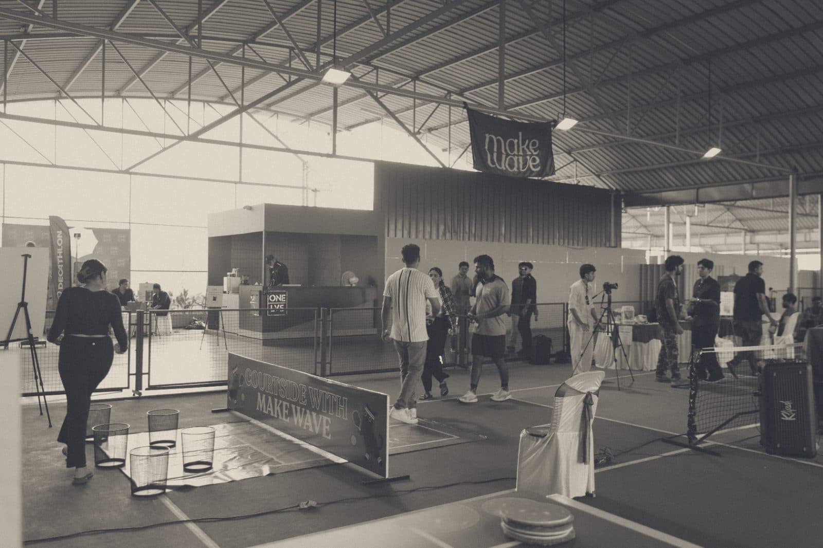 Courtside with MakeWave: people crossing a covered court under a MakeWave banner